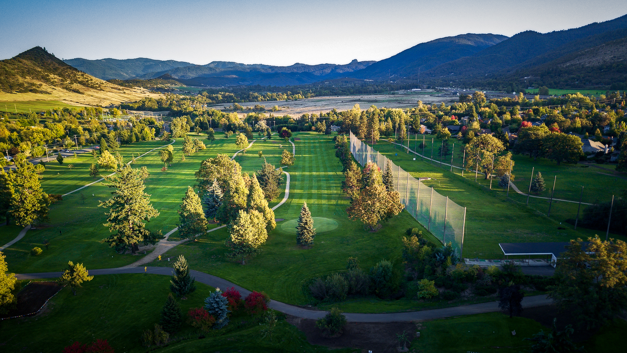 Image of golf ball on tee on grass.